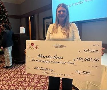 Candice holding a $150,000 check for Alexandra House