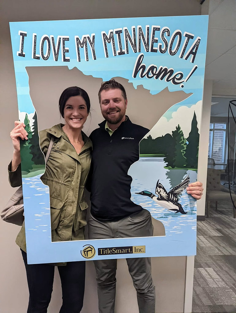 Happy clients in an I Love My Minnesota Home frame