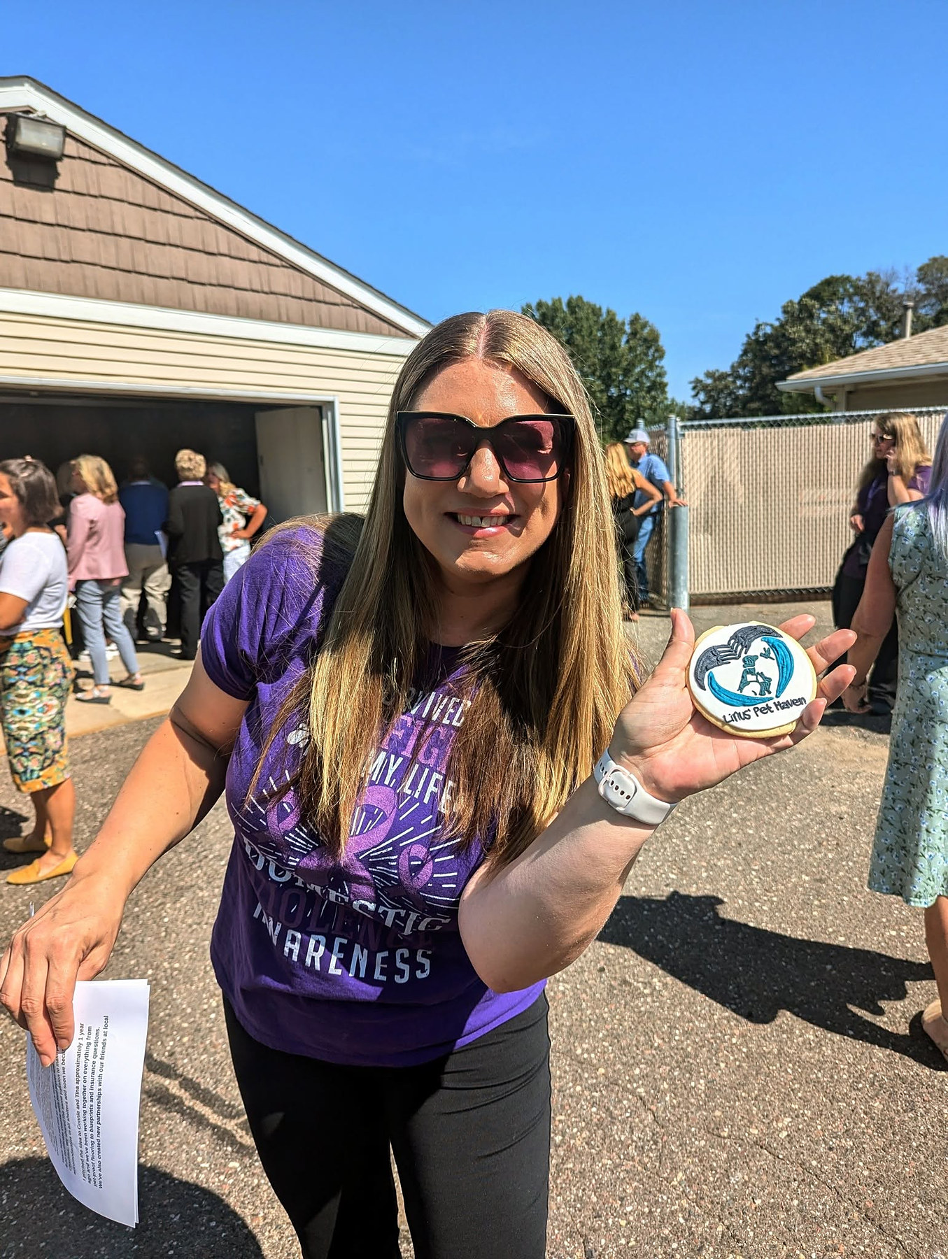 Candice holding a Linus' Pet Haven cookie