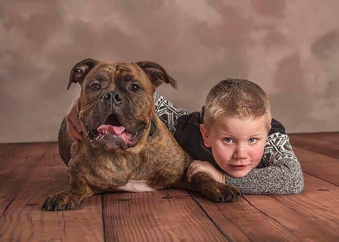 Candice's son Ayden lying beside Linus the bulldog