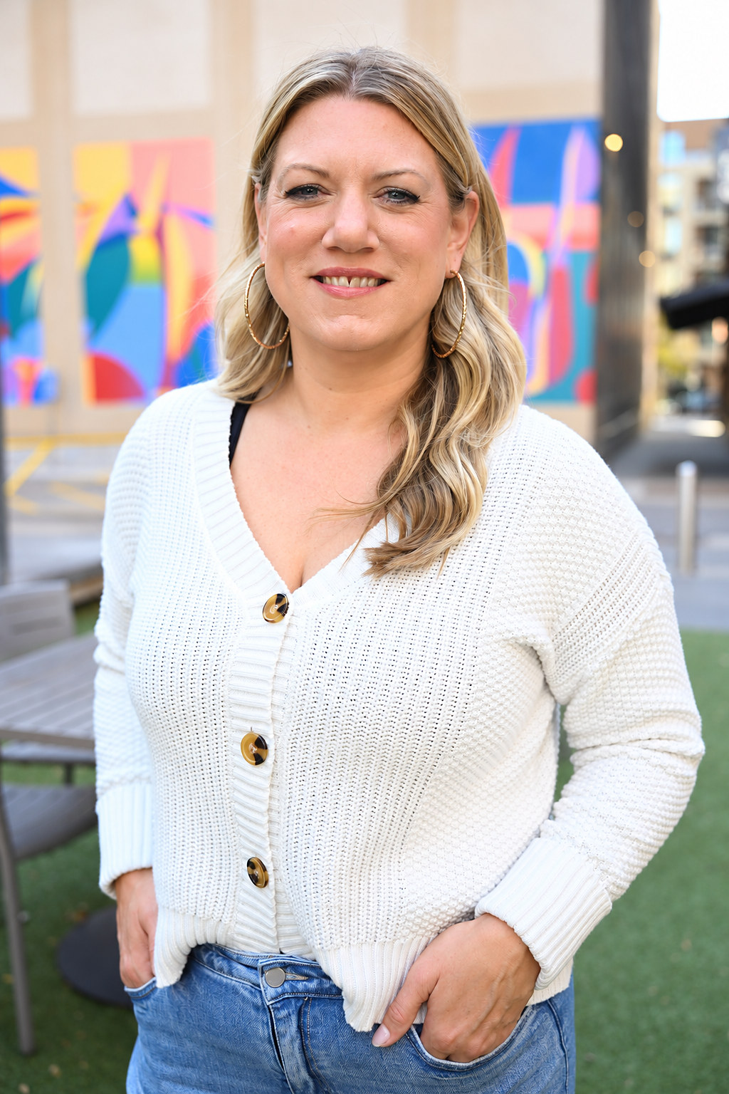 Candice Amundson smiling in a white sweater