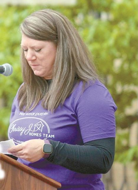 Candice speaking at a podium, featured on the front page of the Vadnais Heights Press